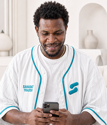A trader following the market on his phone